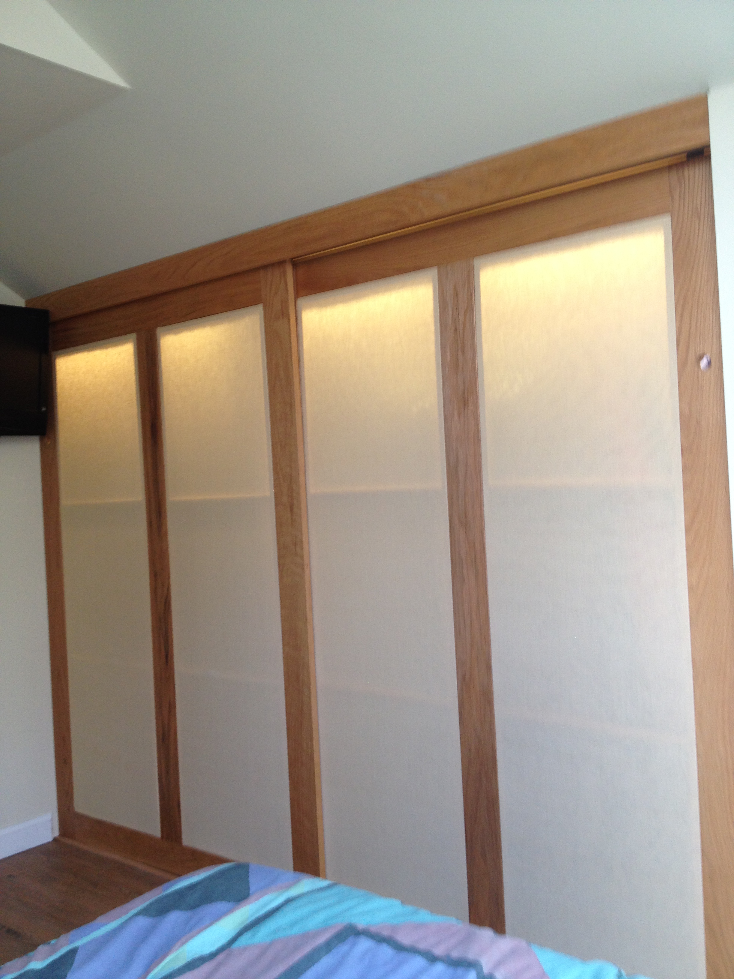 Cheap finished crawl space closet with oak sliding doors