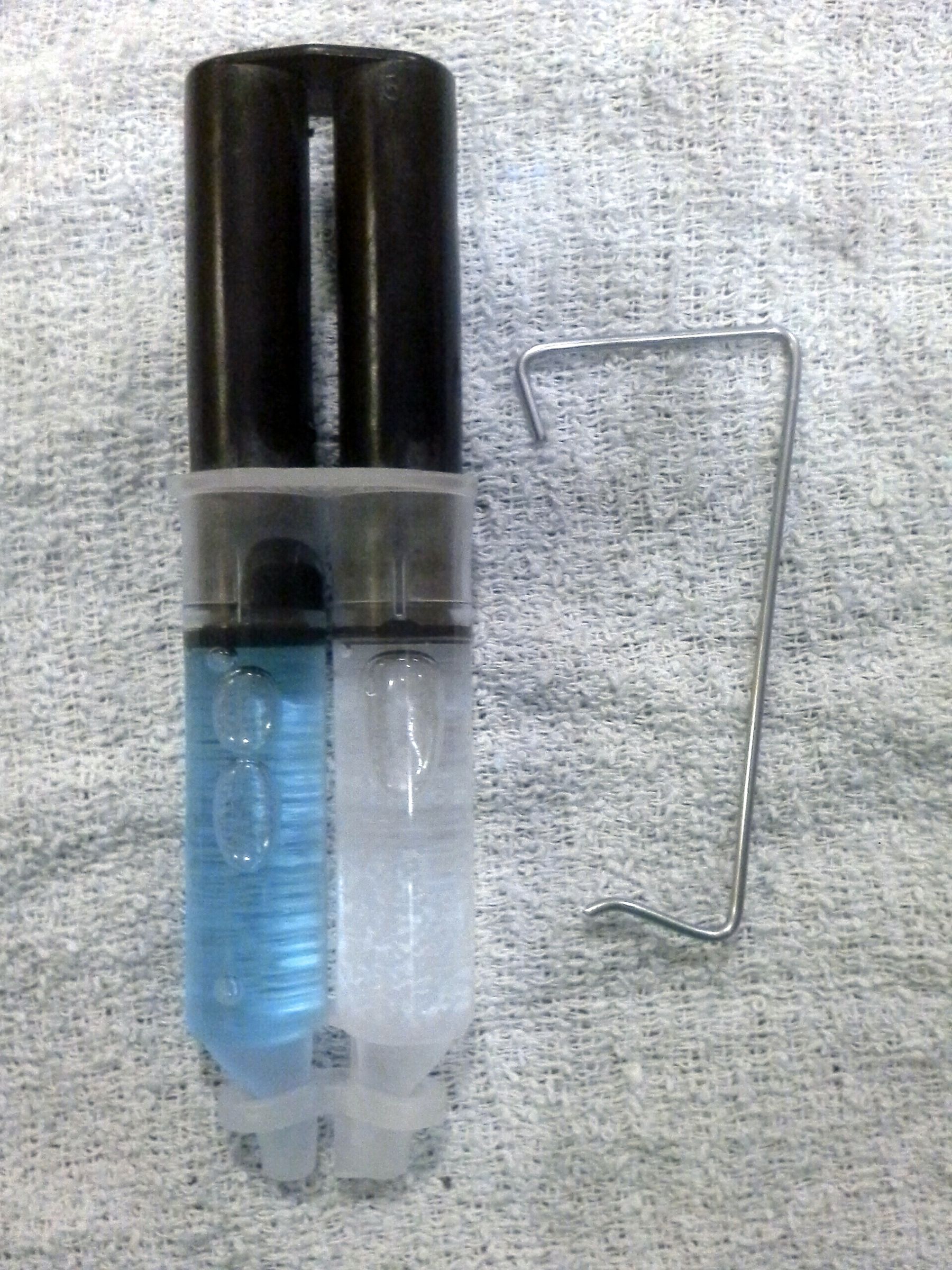 Epoxy tube cap retainer latch; another use for a discarded bicycle spoke