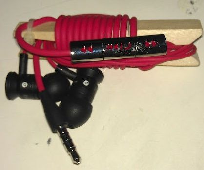 Wooden clothespin earbuds holder