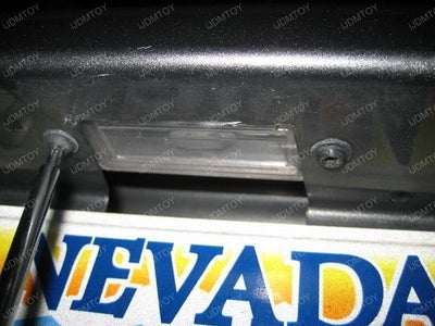Unscrew the Stock License Light's Bolts.