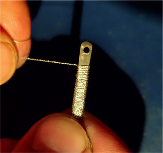 WRAPPING SILVER THREAD ON THE HANDLE.