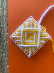 The Web Pattern With White and Yellow Yarn