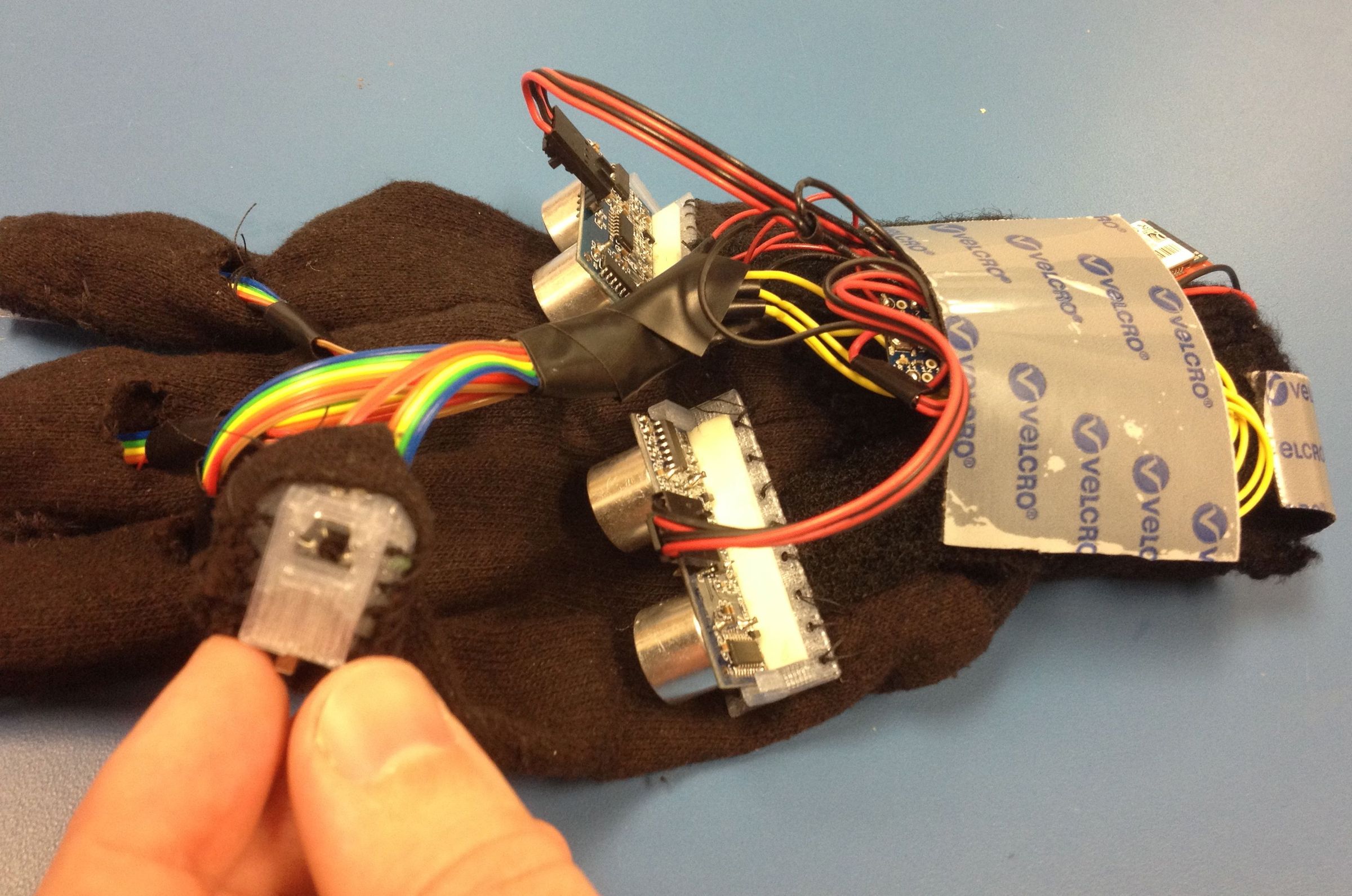 HandSight: a Glove for the Blind to Feel Shapes and Navigate Obstacles