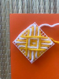 The Web Pattern With White and Yellow Yarn