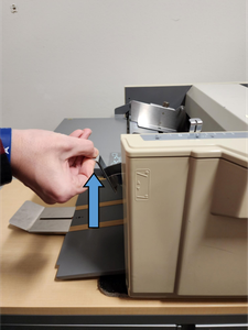 Placing the Paper Into the Machine to Fold
