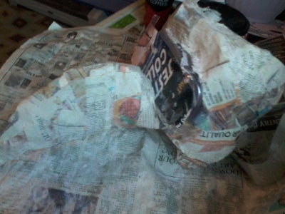 Begin to Cover Mask With Newspaper
