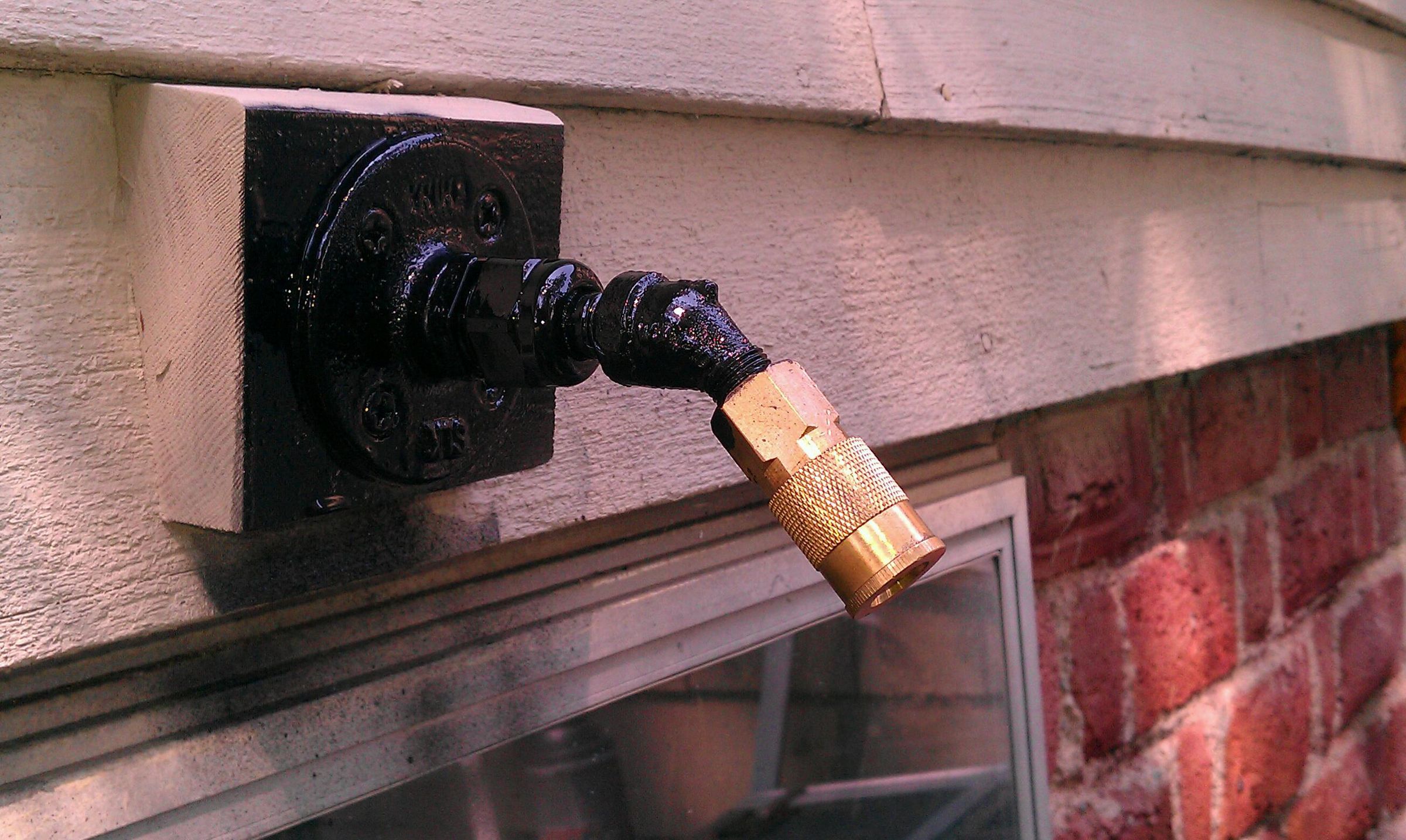 Compressed Air Bulkhead Fitting Outside Wall of House.