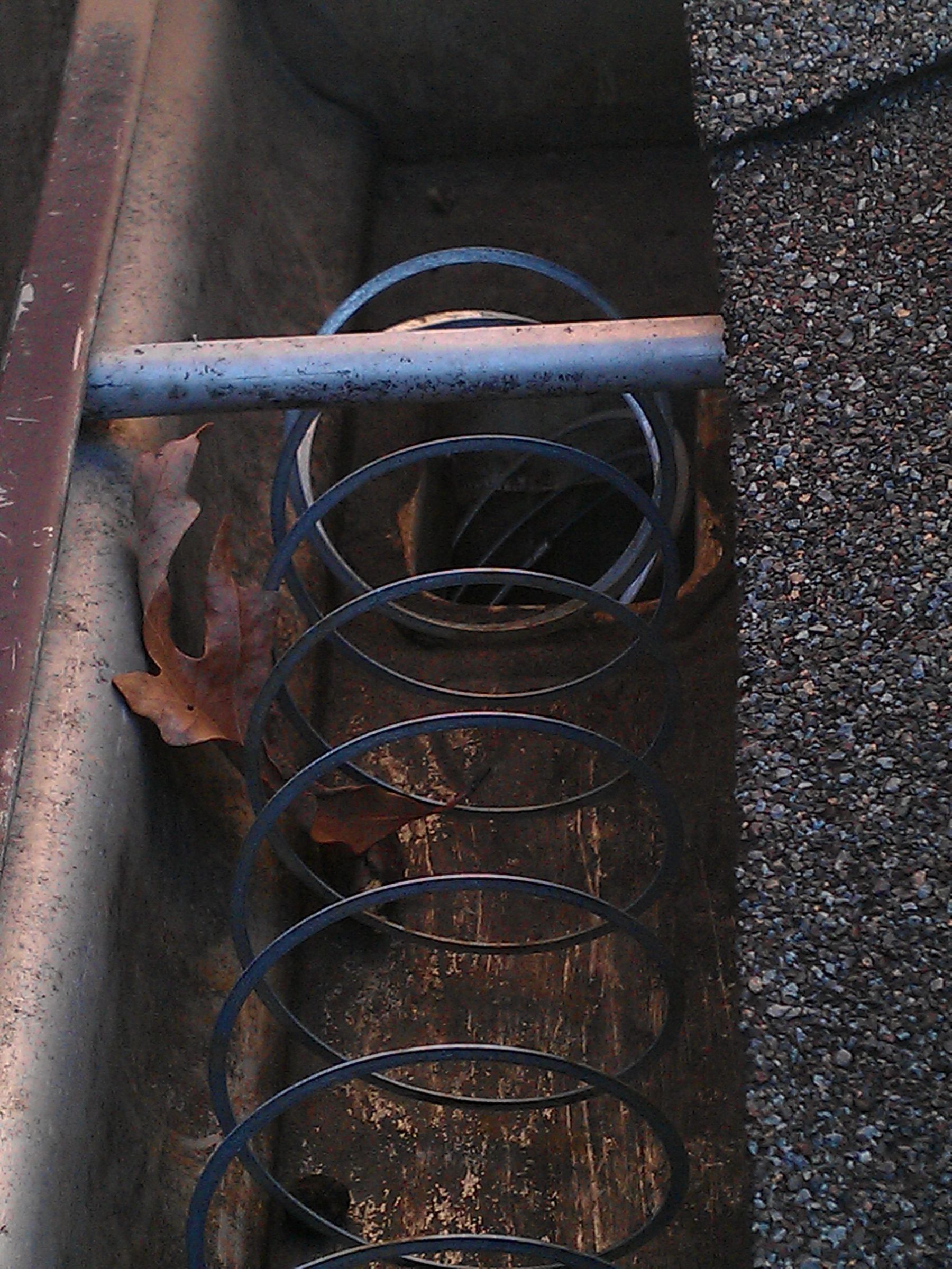 Prevent Gutter Clogging With Slinky;  No Expensive Gutter Guards!