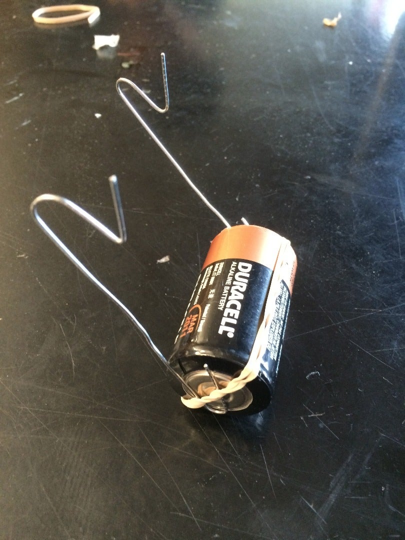 Fasten the Paper Clips to the Battery 