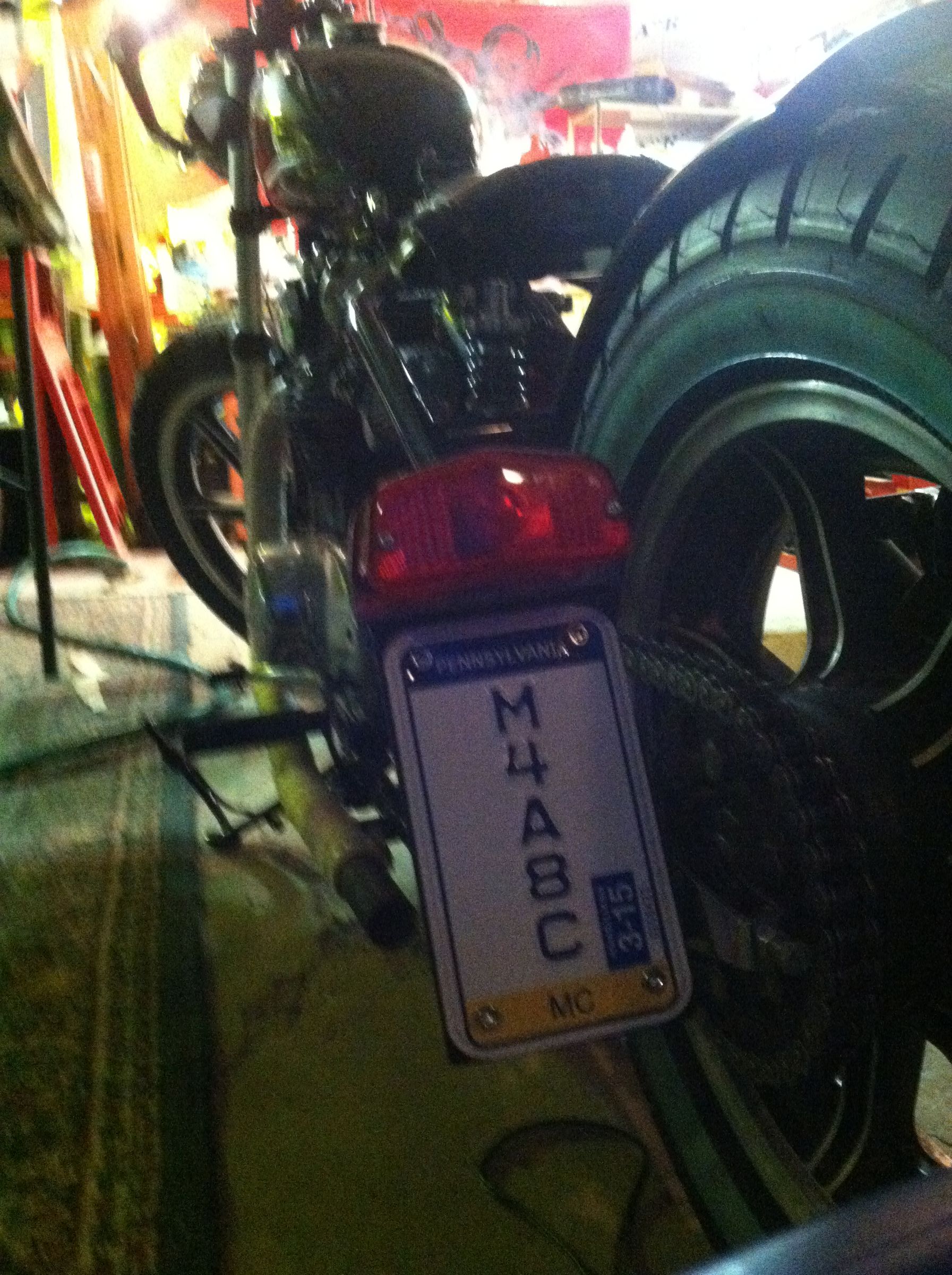 Installing Your New Vertical Motocycle License Plate on the Custom Bracket You Made.