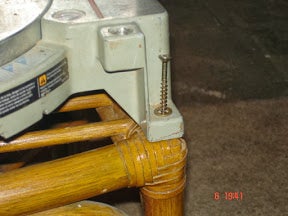 Mounting the Saw to the Chair With the Arms (outrollers) Positioned Under the Saw.