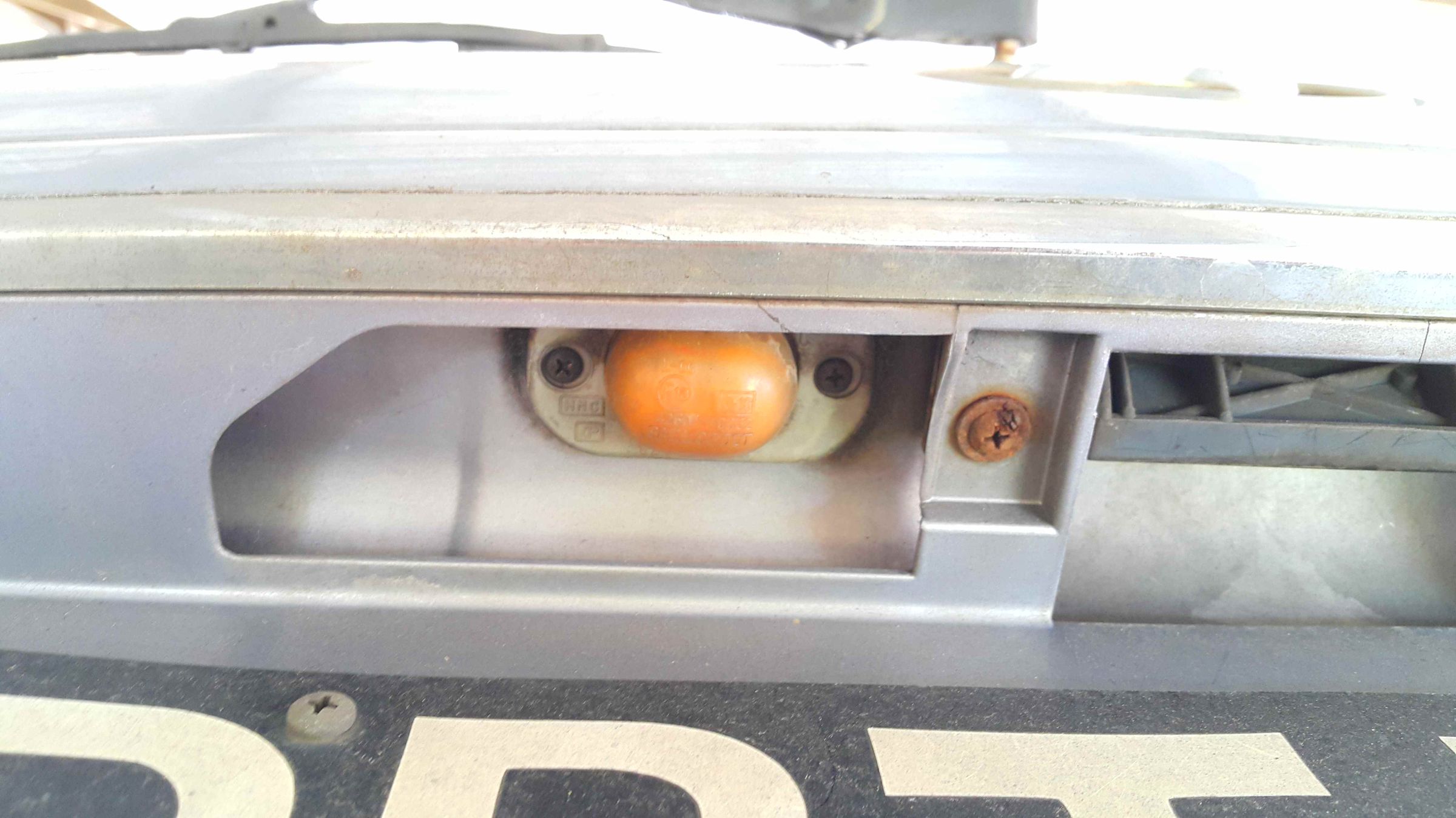 Cleaning License Plate Lamps. 