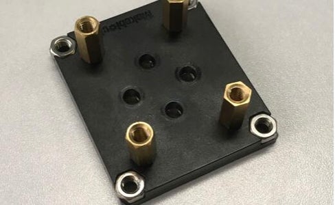 Prepare a Slider Plate and 4 Wheels. Firstly Install Four Copper Cylinders on the Plate, Then Install the Wheels on It. 