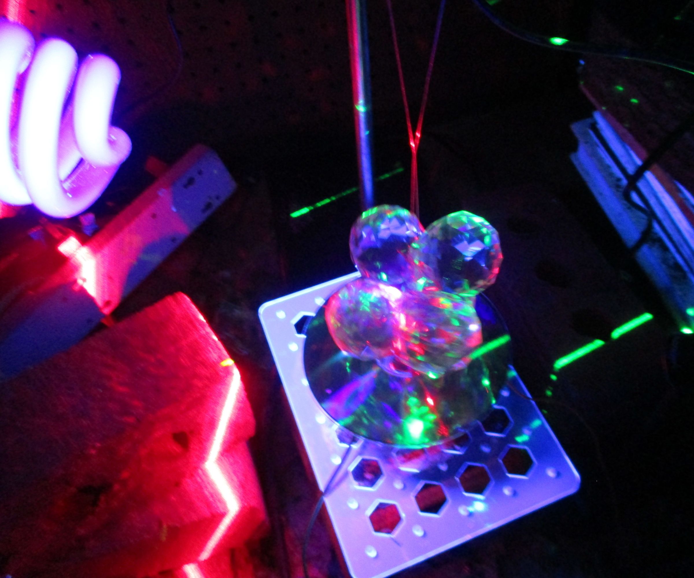 Laser Show With Spherical Prisms and Glowing Chemicals With a Spinning Cd.