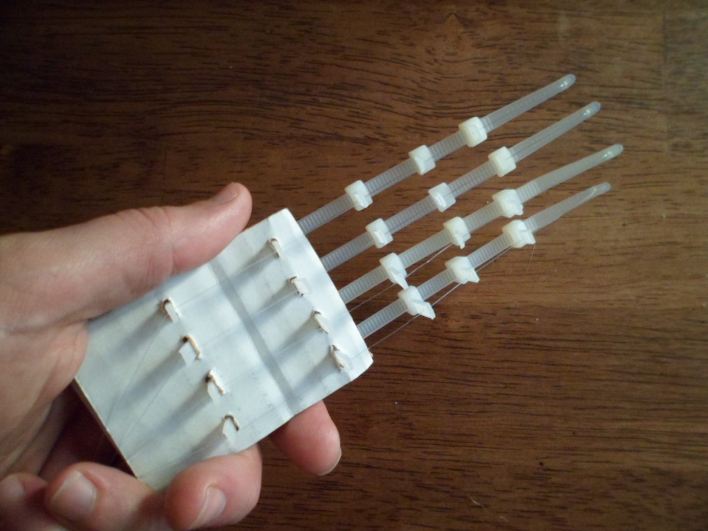 Build a Hand From Zip Ties, Cardboard, and Fishing Line.