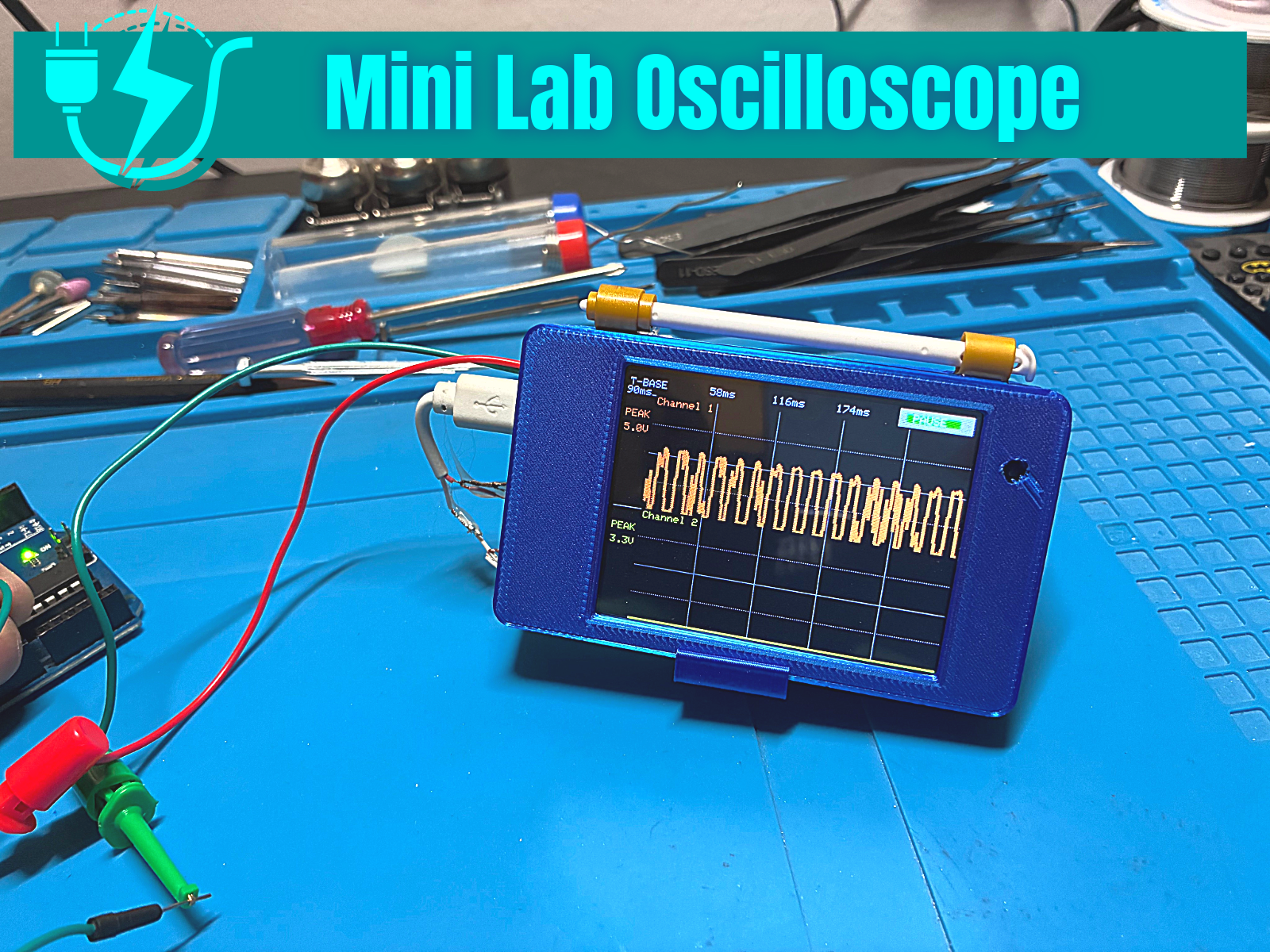 Electronics workbench with development board and test equipment
