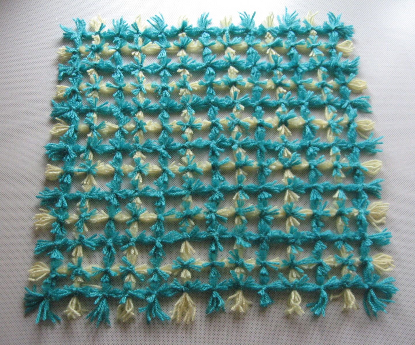 Weaving a Pom Pom Mat