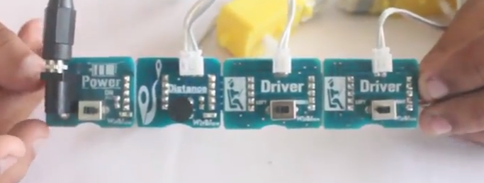 Step 2 - Here We Use Power Block As the Source of Energy Along With Battery, Distance Sensor As Input and Driver With Motors As Output. 