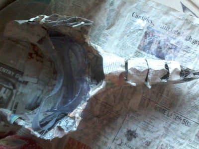 Begin to Cover Mask With Newspaper