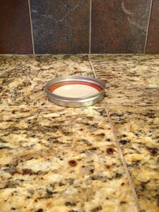 Place Mason Jar Lid Upside Down on a Flat Surface.