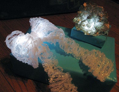 Light Up Bow From Saran Wrap and Hot Glue and LED Throwie