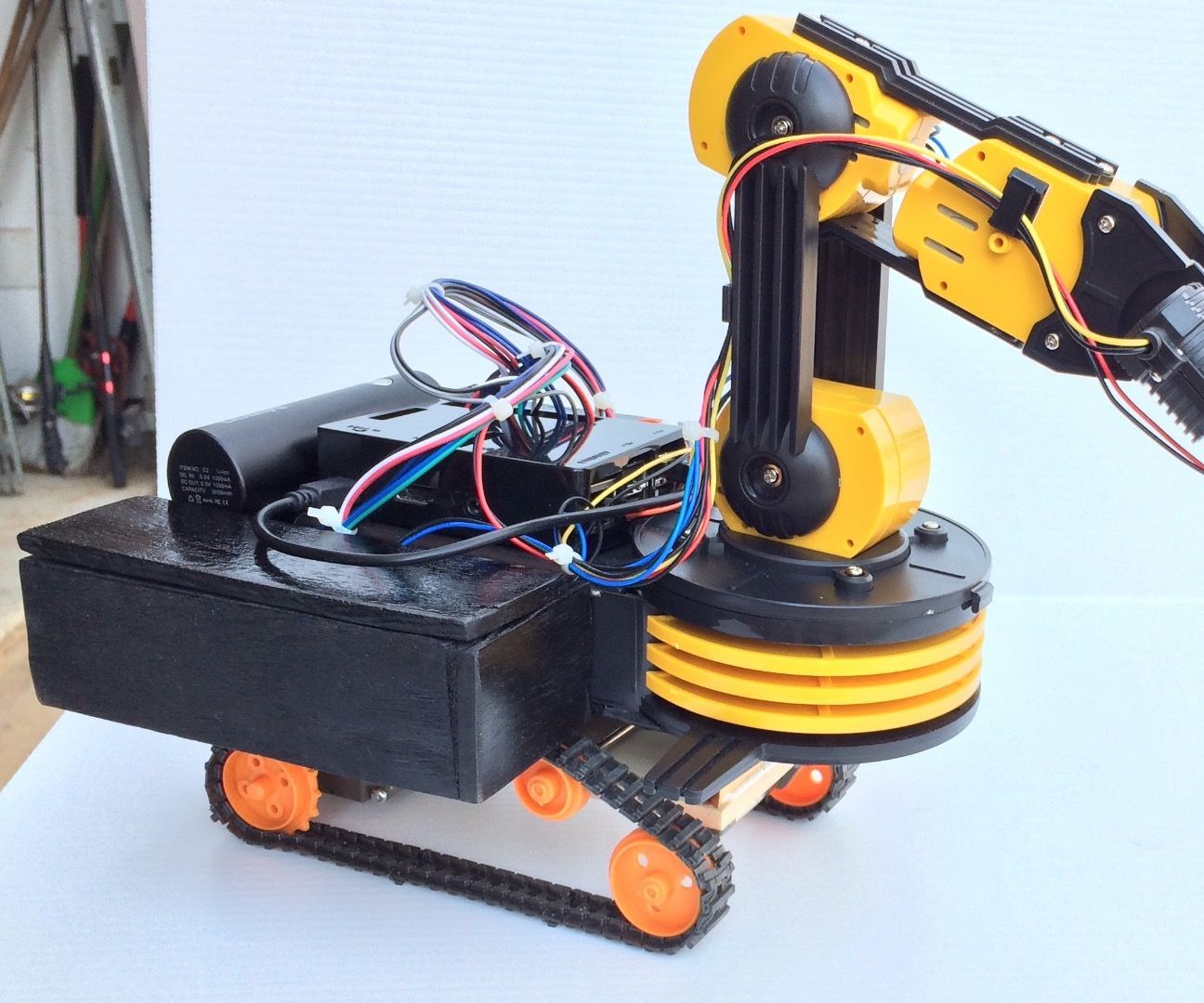 Make OWI Robotic Arm self propelled on tracks controlled wirelessly by the Wii controller and Raspberry Pi