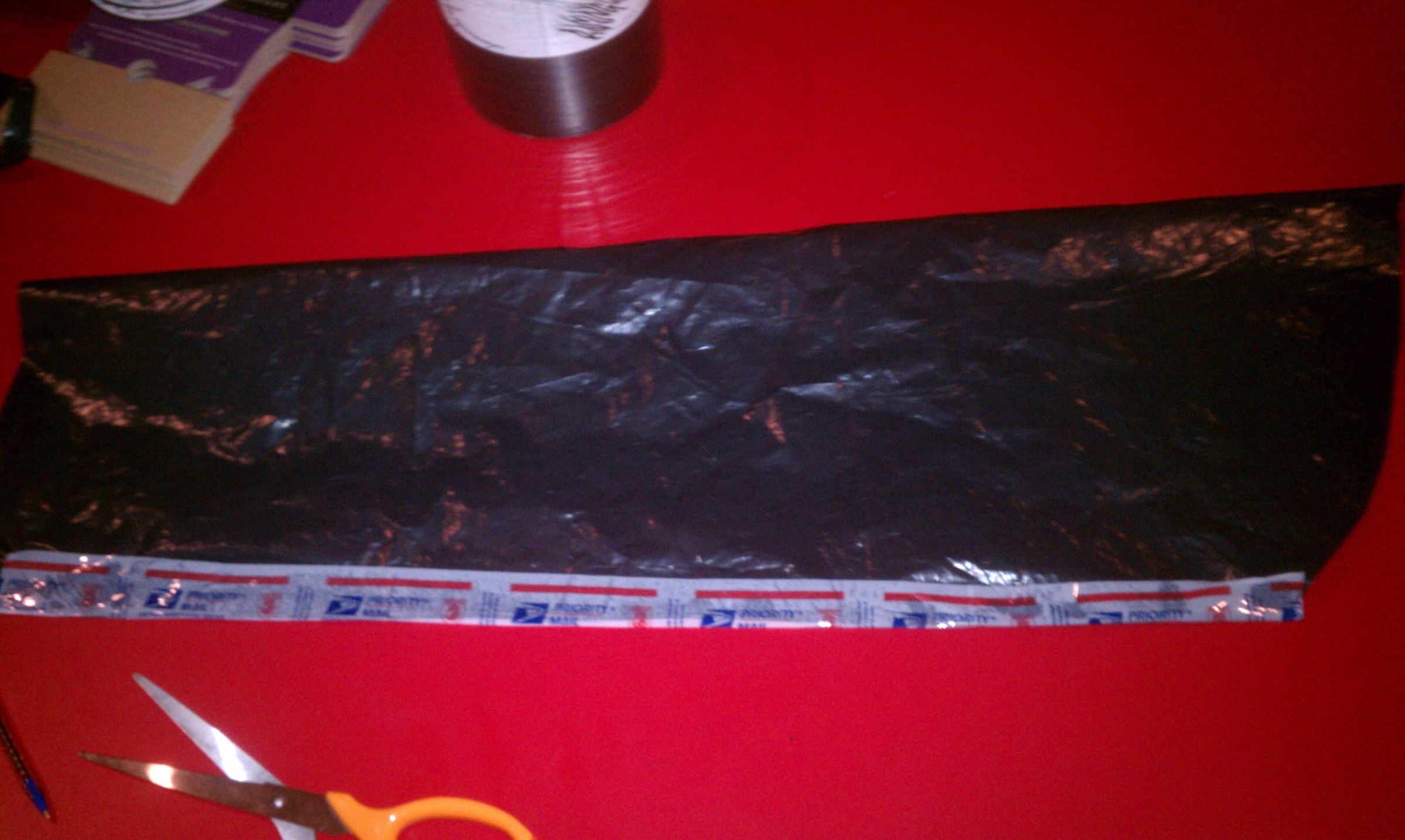 Quick Stylish Raincoat Out of Garbage Bag and USPS Tape 7