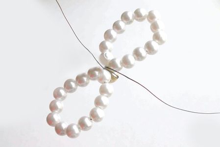 Pull the Wire Tautly and Knot Again on the Back Side.