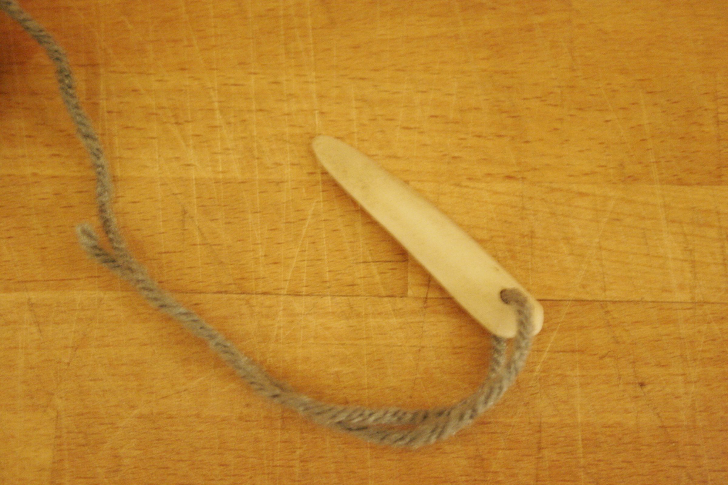 Carve a bone needle for naalbinding
