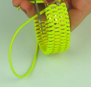 Take 4 Thin Bangles From the Set and Start to Insert the Leather Lace Among Them, in a Meandering Way. 