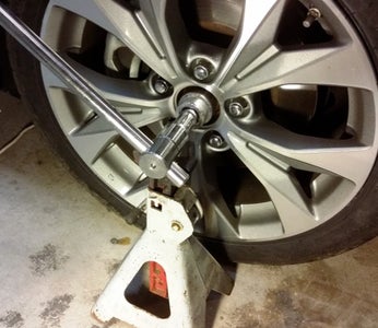 Loosen the Axle Nut and Jack Up the Car