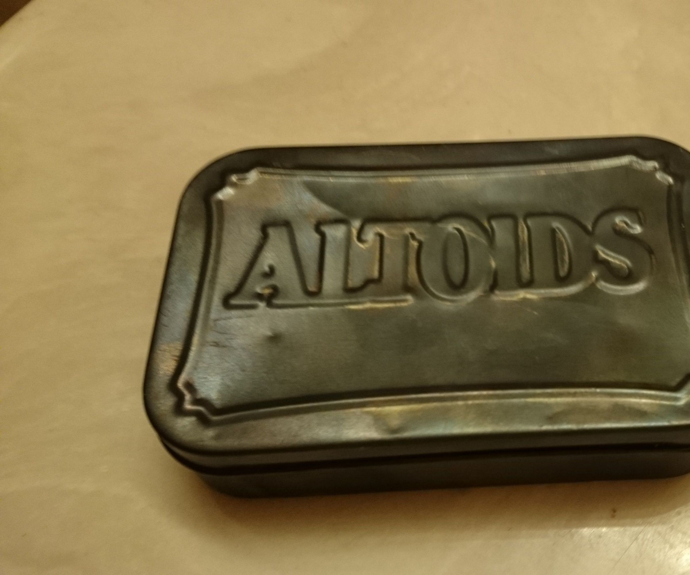 blued Altoids tin can 