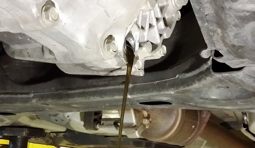 Drain Transmission, Disconnect Control Arms, and Remove Left Axle