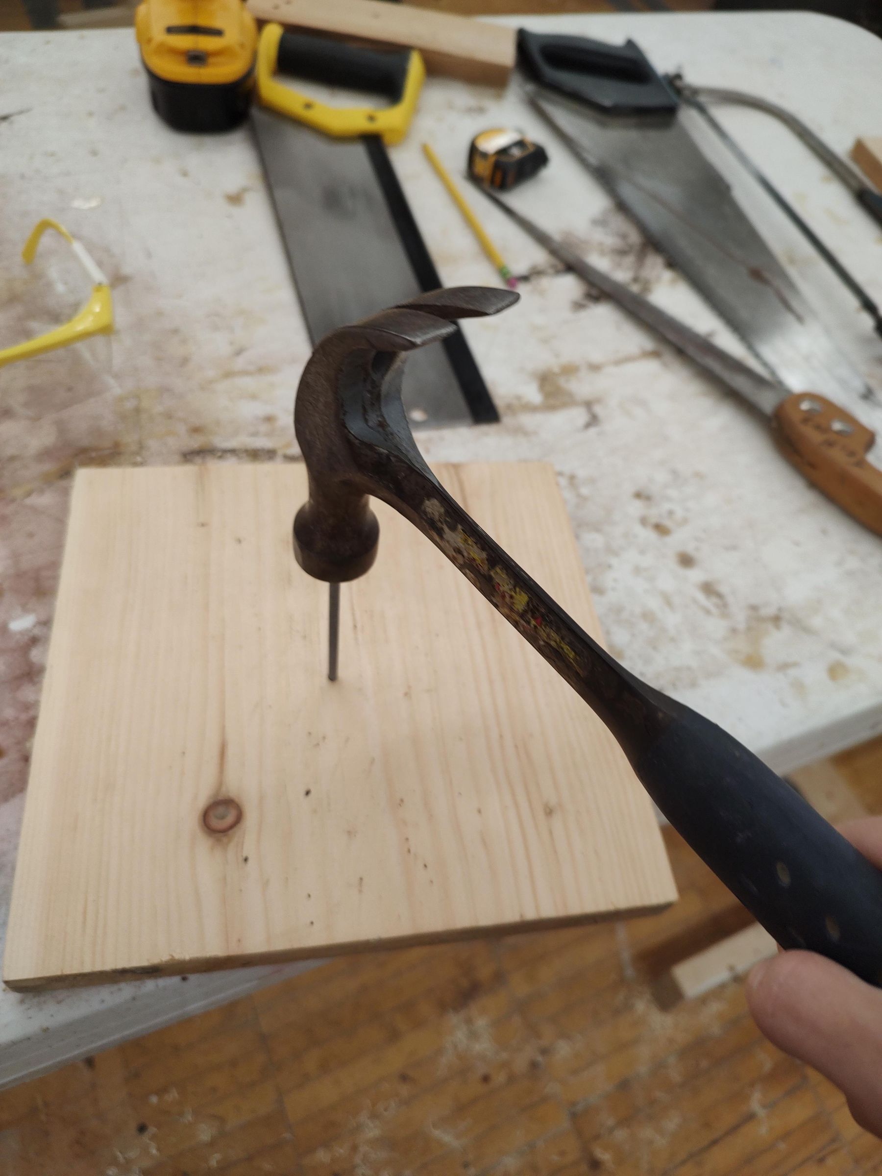How to Hammer a Nail Into a Piece of Wood and Pry It Out 3 Steps