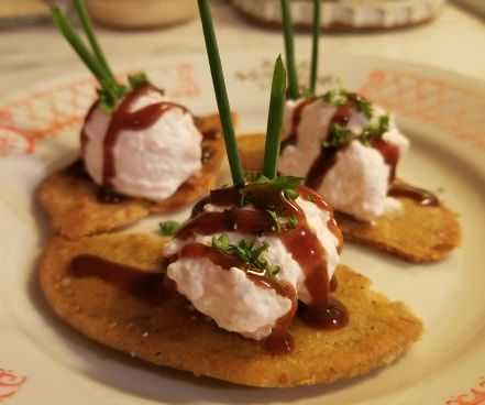 Goat Cheese and Spam Mousse on Millet Pita Chip With Black Cherry, Date and Balsamic Reduction Sauce. 