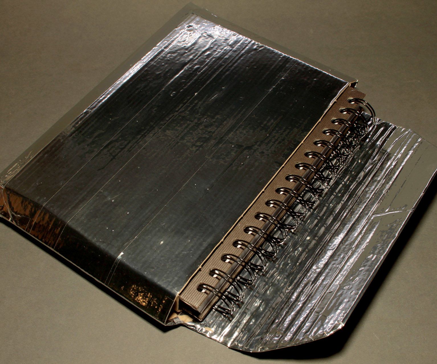 Protective cover for spiral book (or any other book) from amazon packaging (free, 10 min.)