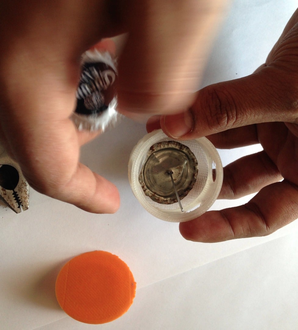 Securing the Caps to the Lid Using Paper Clips