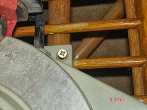 Mounting the Saw to the Chair With the Arms (outrollers) Positioned Under the Saw.