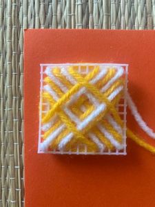 The Web Pattern With White and Yellow Yarn