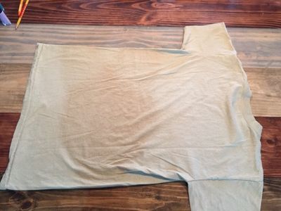 Lay Sand Tee Shirt Flat and Face Down. 