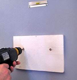 Using Power Drill and Molly Bolts or Screws, Attach 1" X 8" Primed Wood Board