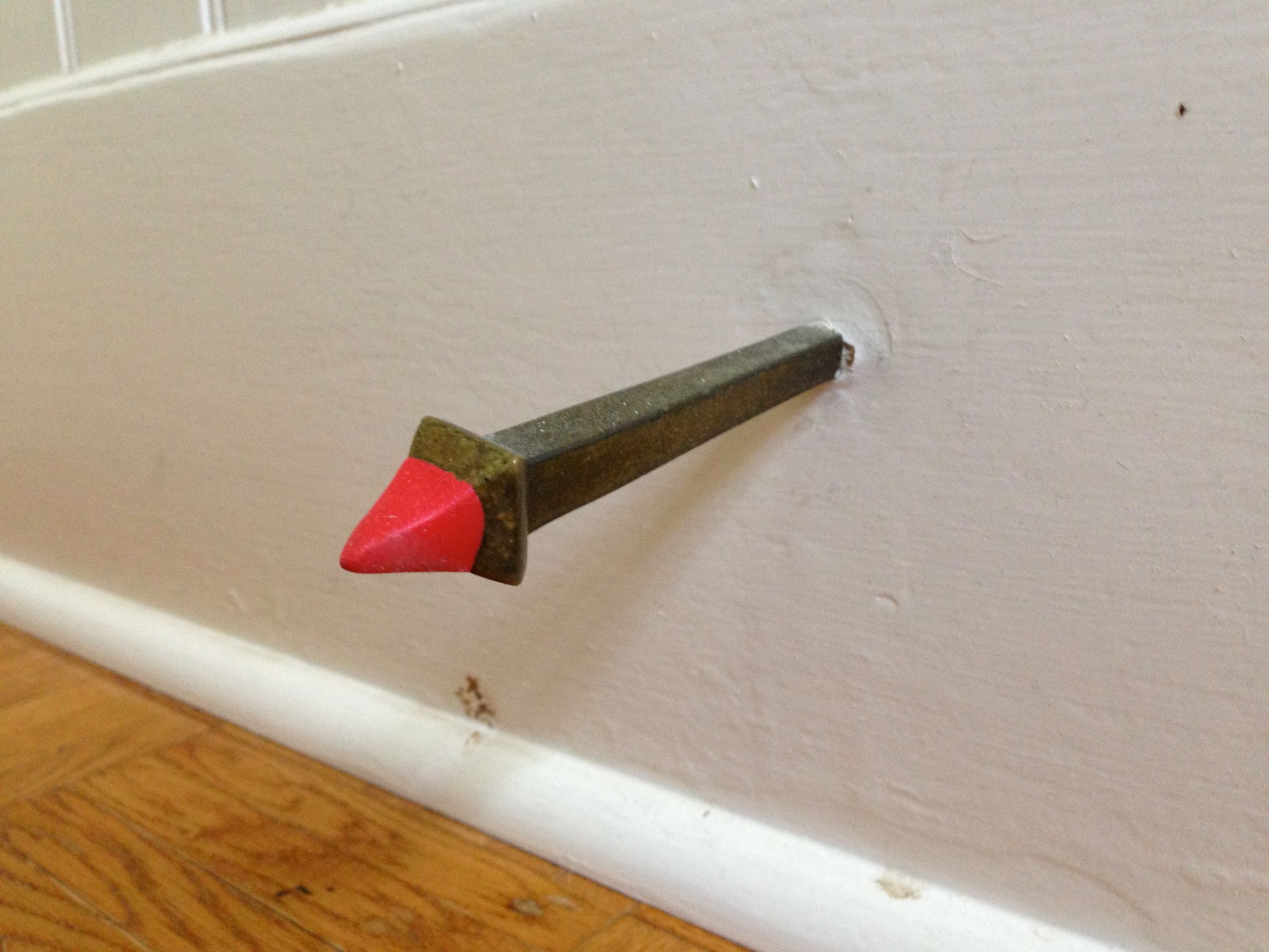 Protect and Silence a Door With a Vintage Nail and Sugru