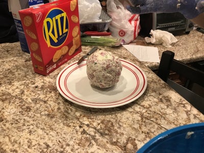 Place Cheese Ball on Plate With the Butter Knife 