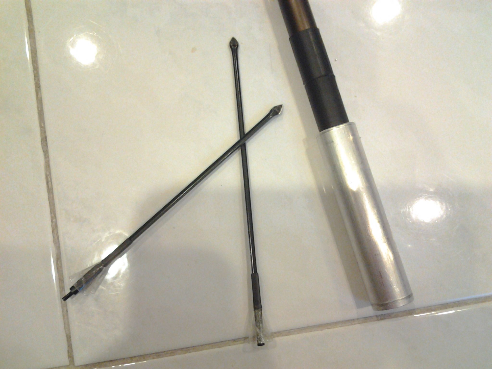 Making blowgun darts from discarded umbrella frame.