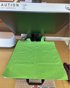 Place Bag on Heat Press and Stick HTV With Transfer Paper on Bag