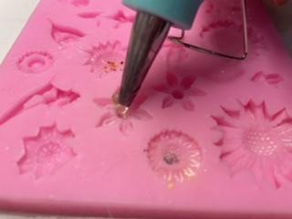 Pouring Hot Glue in the Moulds 