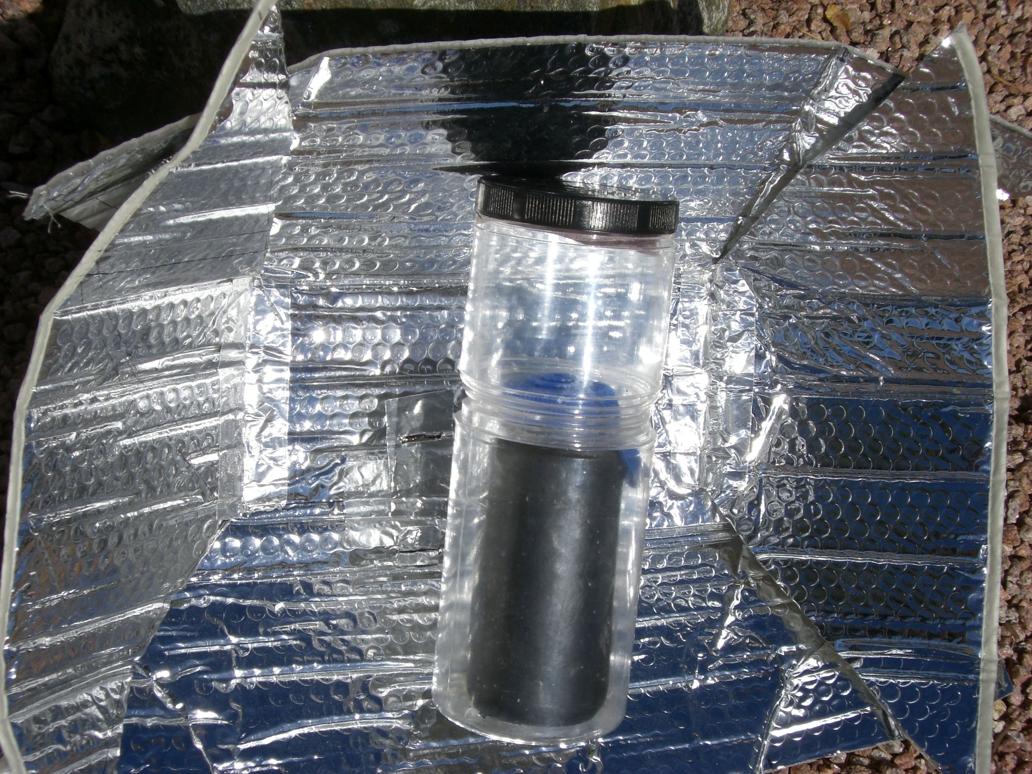 Solar Water Heater for Backpacking Using Water Bottles and a Car Shade