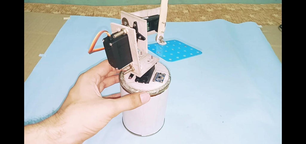 When All the Wires and Components Are Placed Inside a Food Can Then Applied Glue Gun at the Base of Foam Board.