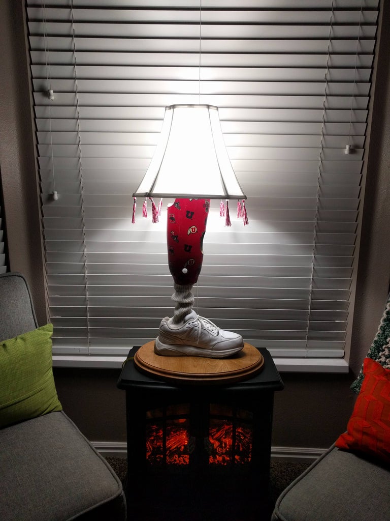 Prosthetic leg converted into an lamp with lampshade and tassels. Prosthetic Leg Lamp